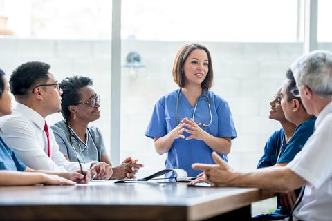 Nurse leads discussion with colleagues