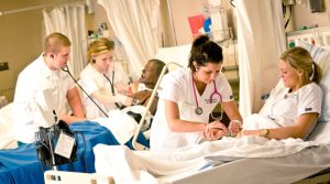 Nurses tending to patients in bed