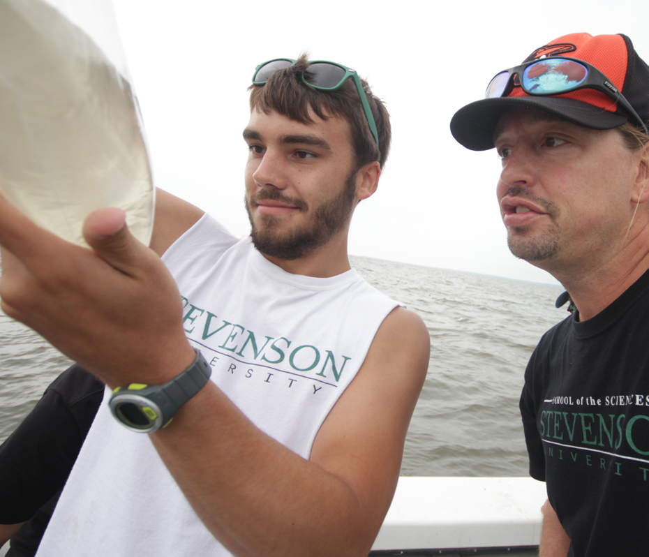 Student and Teacher on boat doing research